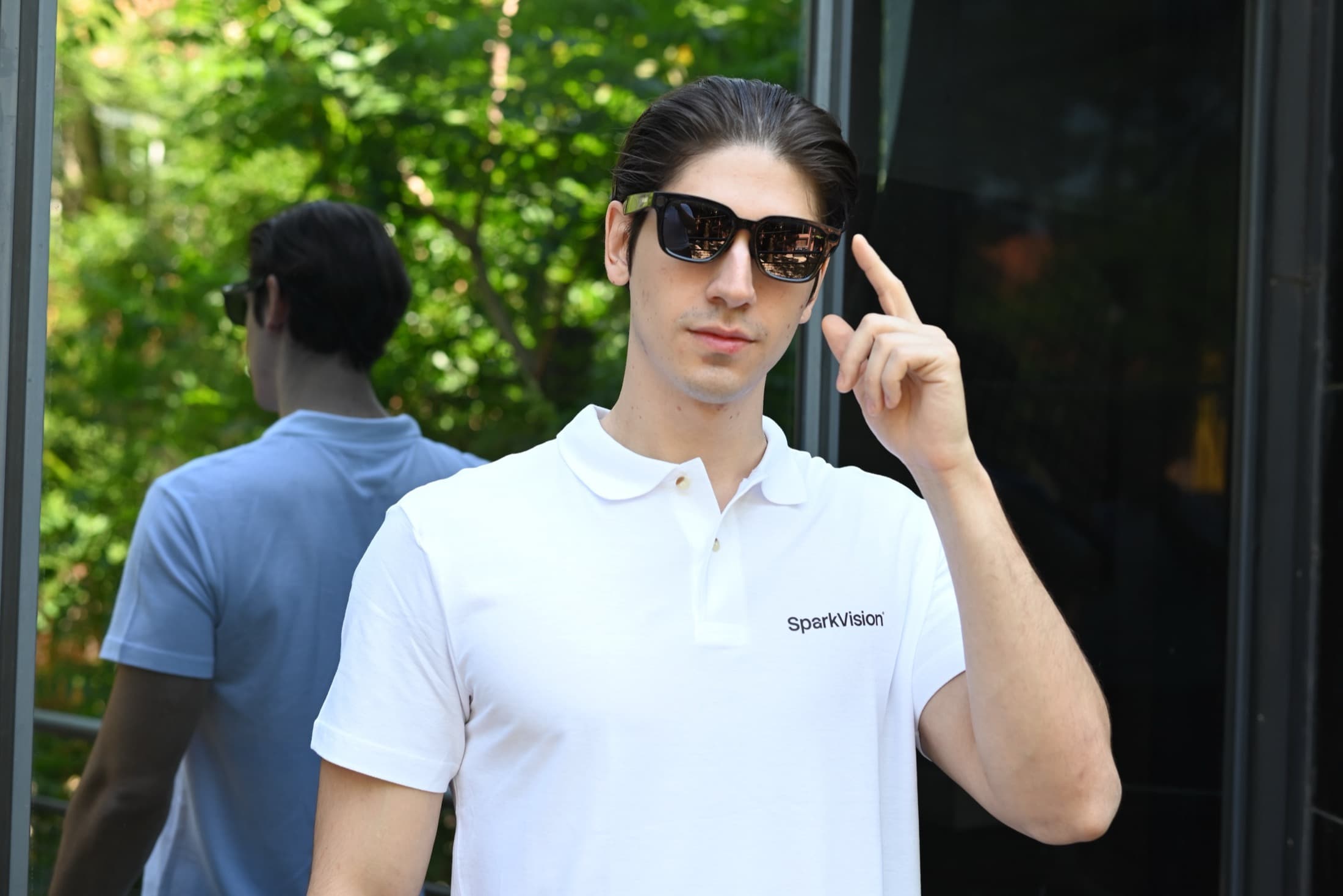 A SparkVision team member testing SparkVision smart glasses outdoors.