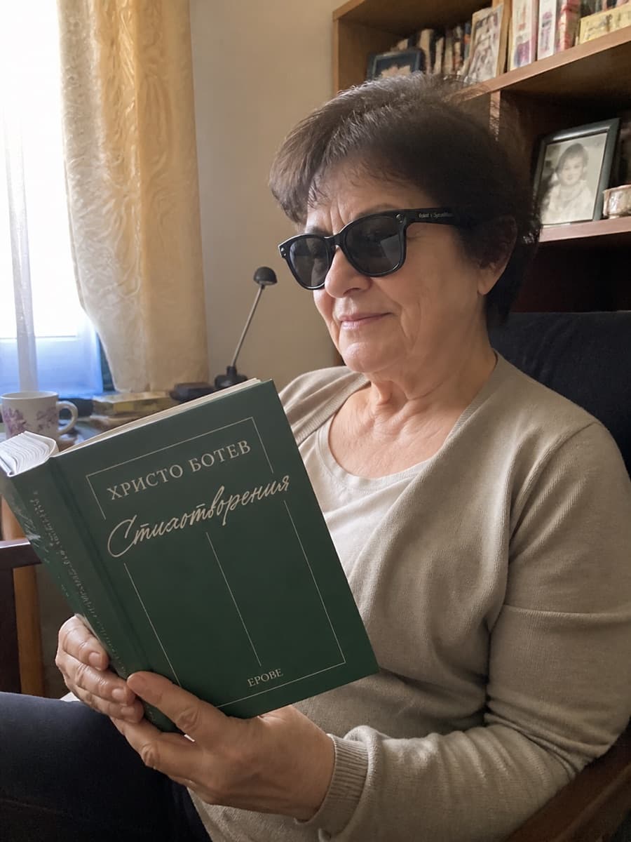A person wearing SparkVision Glasses 2 Ultra reads printed text.